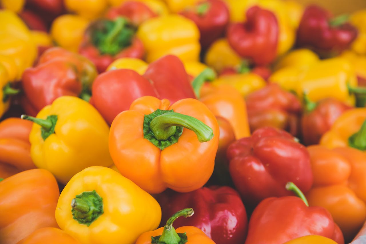 Colorful assortment of fresh, ripe bell peppers in close-up, highlighting food freshness.